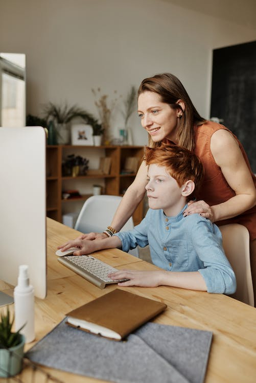 a mother helping her son specify his academic goals online